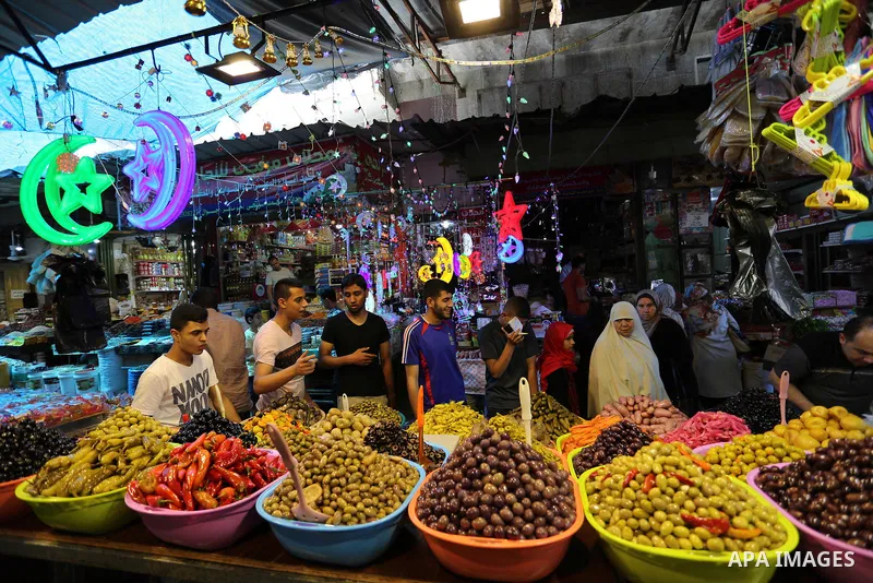 A Palestinian vendor sells pickles at a market ahead of the Muslim holy month of Ramadan, in Gaza city, on May 25, 2017 as the faithful prepare to start fasting. Photo by Ashraf Amra