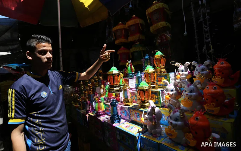 A Palestinian vendor displays traditional lanterns known in Arabic as "Fanous" at a market ahead of the Muslim holy month of Ramadan, in Gaza city, on May 25, 2017 as the faithful prepare to start fasting. Photo by Ashra...