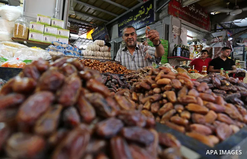 A Palestinian vendor sells dates at a market ahead of the Muslim holy month of Ramadan, in Gaza city, on May 25, 2017 as the faithful prepare to start fasting. Photo by Ashraf Amra