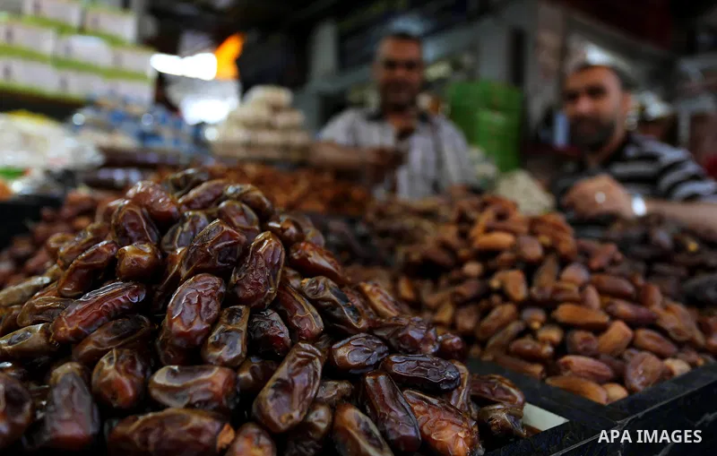 A Palestinian vendor sells dates at a market ahead of the Muslim holy month of Ramadan, in Gaza city, on May 25, 2017 as the faithful prepare to start fasting. Photo by Ashraf Amra