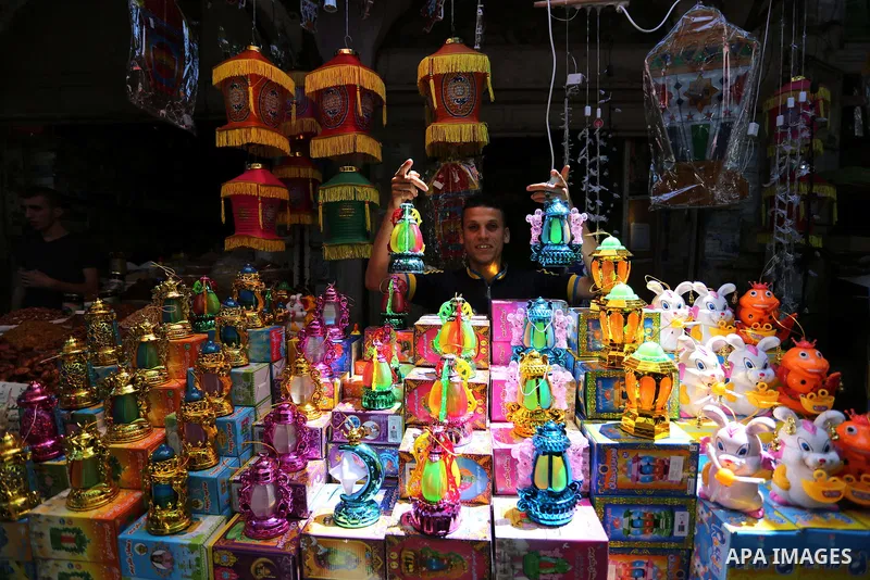 A Palestinian vendor displays traditional lanterns known in Arabic as "Fanous" at a market ahead of the Muslim holy month of Ramadan, in Gaza city, on May 25, 2017 as the faithful prepare to start fasting. Photo by Ashra...