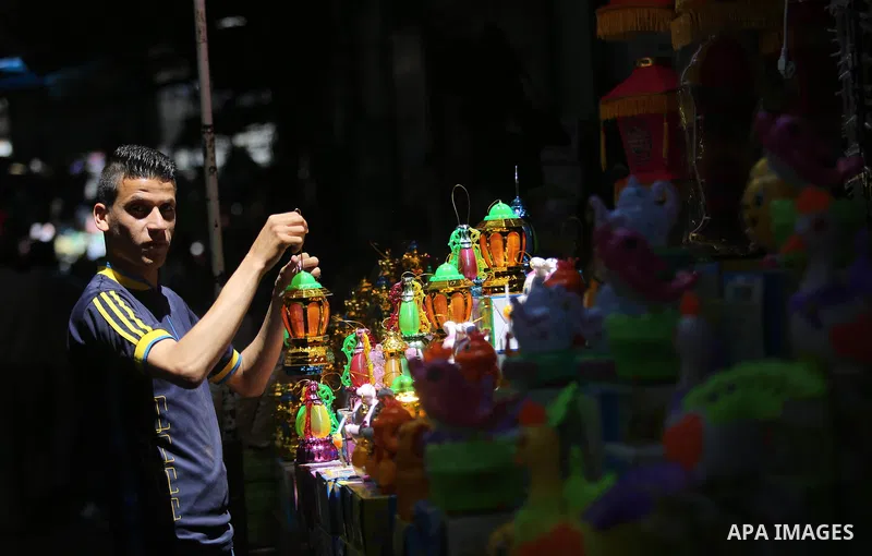 A Palestinian vendor displays traditional lanterns known in Arabic as "Fanous" at a market ahead of the Muslim holy month of Ramadan, in Gaza city, on May 25, 2017 as the faithful prepare to start fasting. Photo by Ashra...