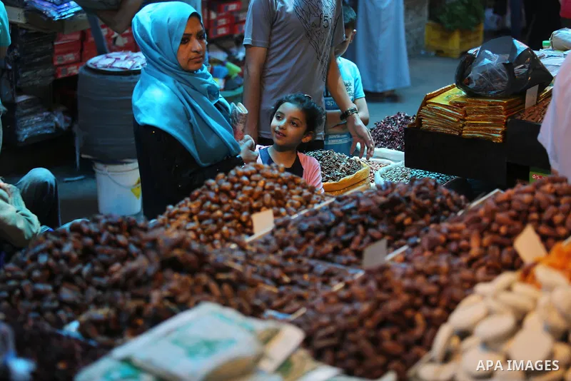 A Palestinian vendor sells dates at a market ahead of the Muslim holy month of Ramadan, in Gaza city, on May 25, 2017 as the faithful prepare to start fasting. Photo by Ashraf Amra