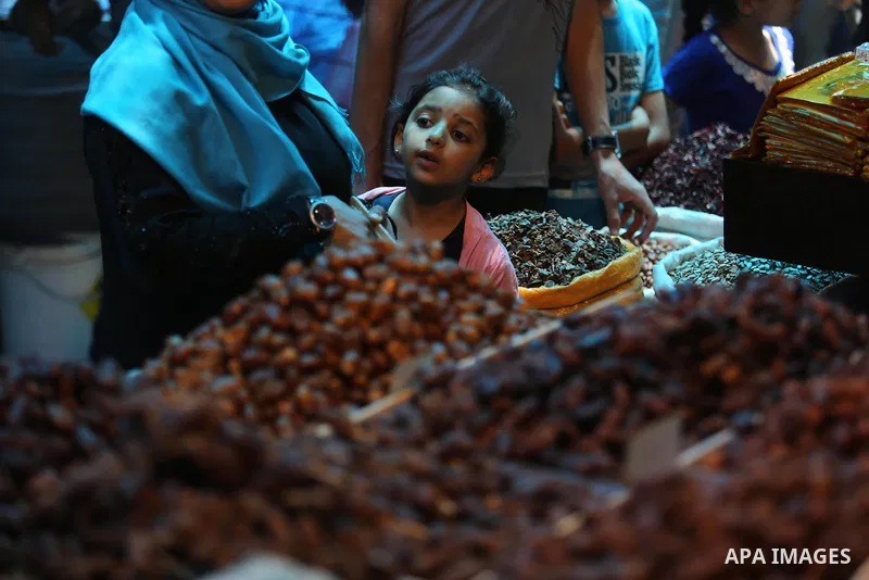 A Palestinian vendor sells dates at a market ahead of the Muslim holy month of Ramadan, in Gaza city, on May 25, 2017 as the faithful prepare to start fasting. Photo by Ashraf Amra