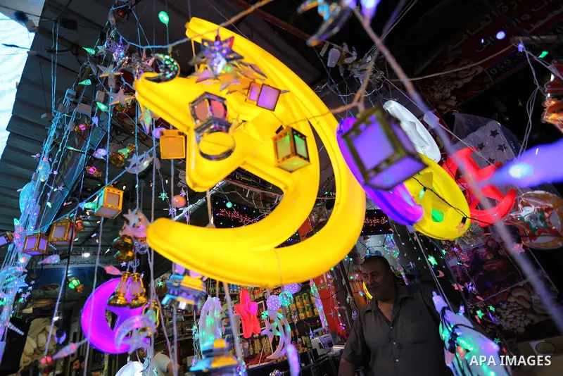 A Palestinian vendor displays traditional lanterns known in Arabic as "Fanous" at a market ahead of the Muslim holy month of Ramadan, in Gaza city, on May 25, 2017 as the faithful prepare to start fasting. Photo by Ashra...