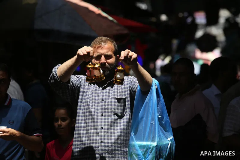 A Palestinian vendor displays traditional lanterns known in Arabic as "Fanous" at a market ahead of the Muslim holy month of Ramadan, in Gaza city, on May 25, 2017 as the faithful prepare to start fasting. Photo by Ashra...