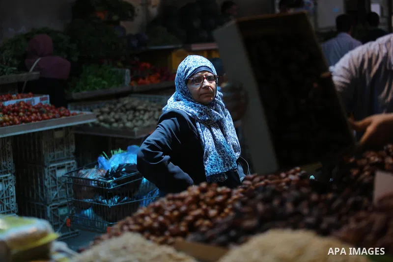 A Palestinian vendor sells dates at a market ahead of the Muslim holy month of Ramadan, in Gaza city, on May 25, 2017 as the faithful prepare to start fasting. Photo by Ashraf Amra