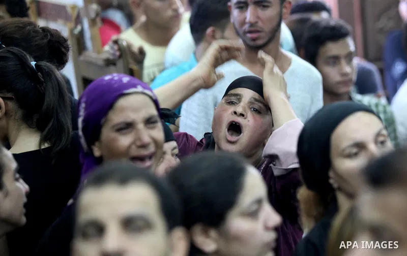 Relatives of the Coptic Christians victims mourn during their funeral at Abu Garnous Cathedral in Minya, some 260 kms south of the capital Cairo, on May 26, 2017. Masked gunmen attacked a bus carrying Coptic Christians o...