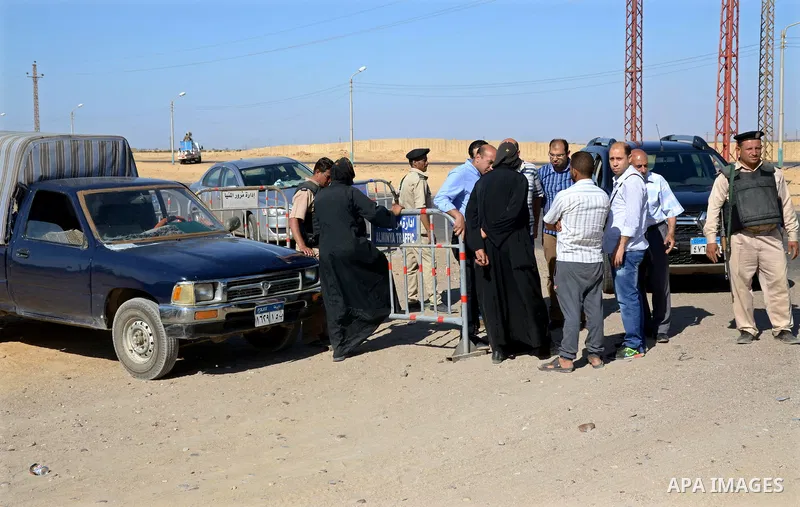 Egyptian policemen stand guard at the entrance of a road leading to Saint Samuel monastery in Minya province, some 260 kms south of the capital Cairo, on May 26, 2017. Masked gunmen attacked a bus carrying Coptic Christi...