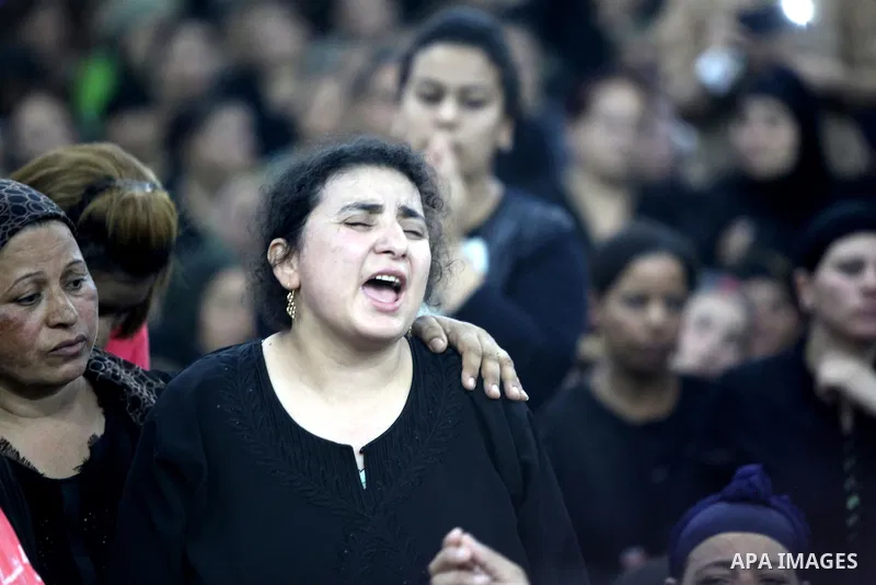 Relatives of the Coptic Christians victims mourn during their funeral at Abu Garnous Cathedral in Minya, some 260 kms south of the capital Cairo, on May 26, 2017. Masked gunmen attacked a bus carrying Coptic Christians o...