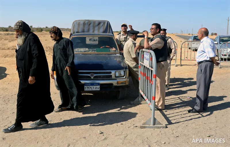 Egyptian policemen stand guard at the entrance of a road leading to Saint Samuel monastery in Minya province, some 260 kms south of the capital Cairo, on May 26, 2017. Masked gunmen attacked a bus carrying Coptic Christi...