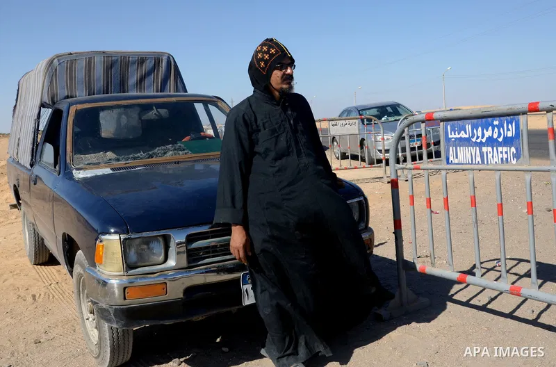 Egyptian policemen stand guard at the entrance of a road leading to Saint Samuel monastery in Minya province, some 260 kms south of the capital Cairo, on May 26, 2017. Masked gunmen attacked a bus carrying Coptic Christi...