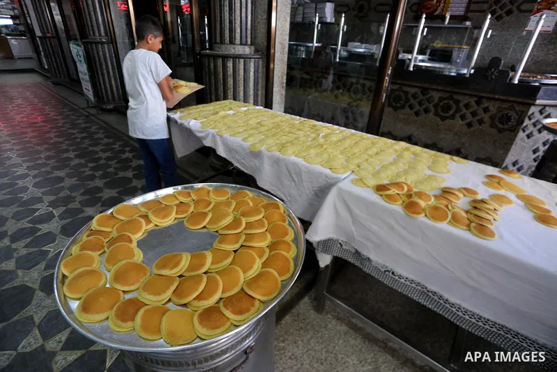 A Palestinian vendor prepares traditional pancakes known as ''Qatayef'' on the holy month of Ramadan at market in Gaza city on May 27, 2017. Ramadan is sacred to Muslims because it is during that month that tradition say...