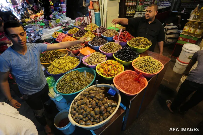 A Palestinian vendor sells dates and pickles on the holy month of Ramadan at market in Gaza city on May 27, 2017. Ramadan is sacred to Muslims because it is during that month that tradition says the Koran was revealed to...