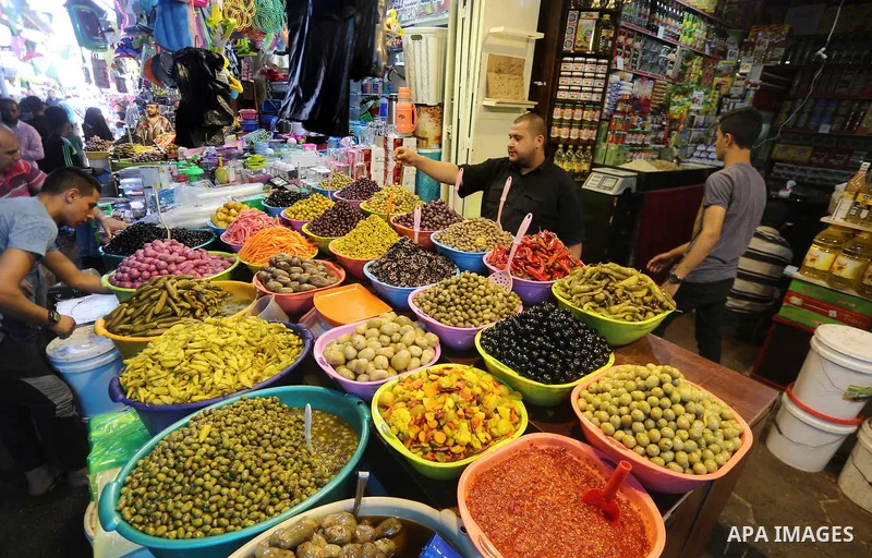 A Palestinian vendor sells dates and pickles on the holy month of Ramadan at market in Gaza city on May 27, 2017. Ramadan is sacred to Muslims because it is during that month that tradition says the Koran was revealed to...