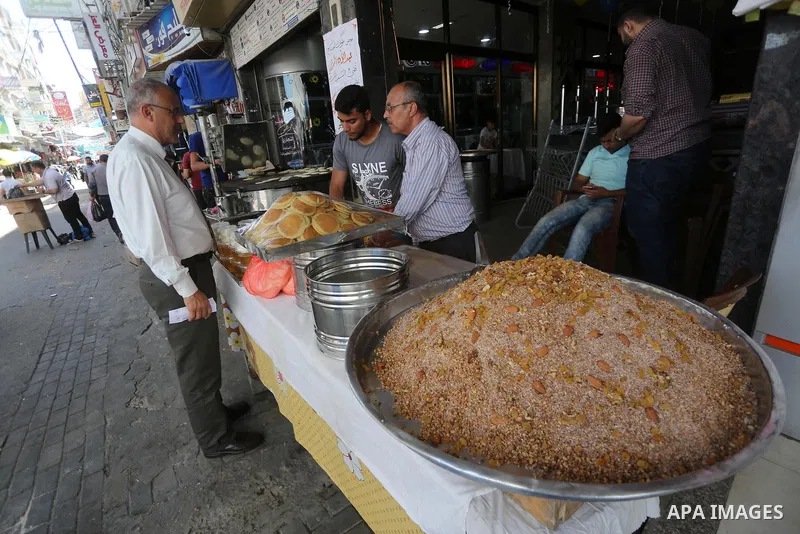 A Palestinian vendor prepares traditional pancakes known as ''Qatayef'' on the holy month of Ramadan at market in Gaza city on May 27, 2017. Ramadan is sacred to Muslims because it is during that month that tradition say...