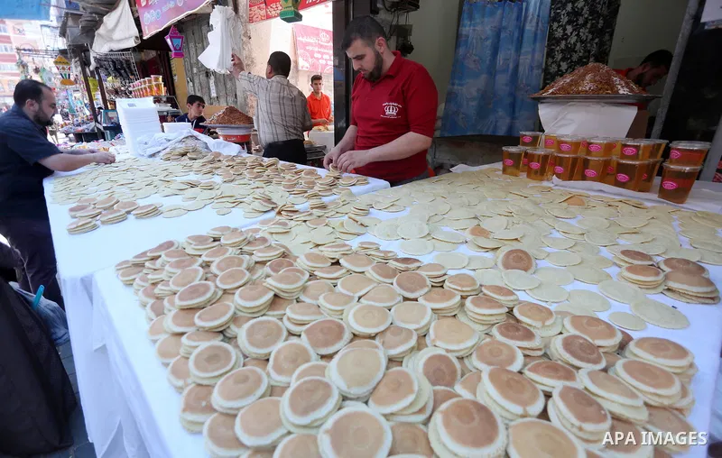 A Palestinian vendor prepares traditional pancakes known as ''Qatayef'' on the holy month of Ramadan at market in Gaza city on May 27, 2017. Ramadan is sacred to Muslims because it is during that month that tradition say...