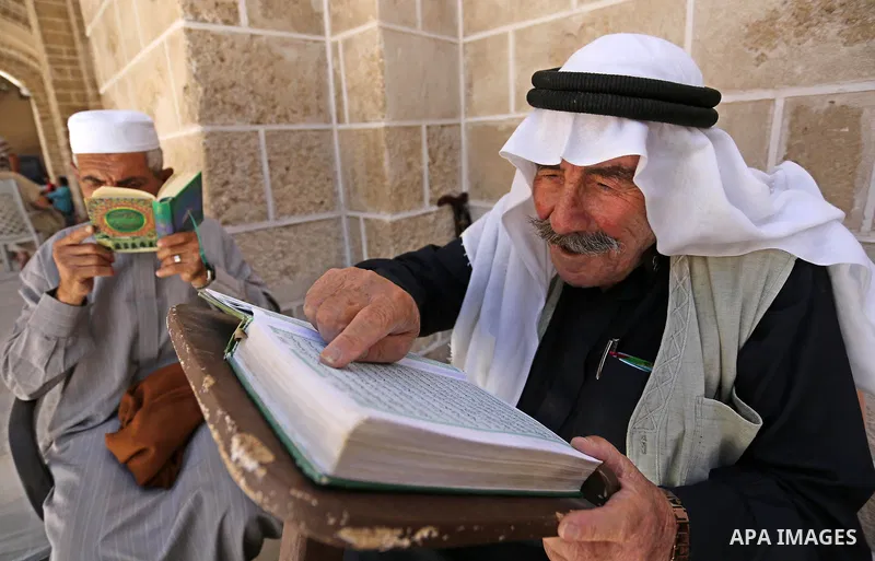 Palestinians read copies of the Koran, Islam's holiest book, on the first day of fasting in the Muslim holy month of Ramadan, at the al-Omari mosque in Gaza City, on May 27, 2017. Ramadan is sacred to Muslims because it...