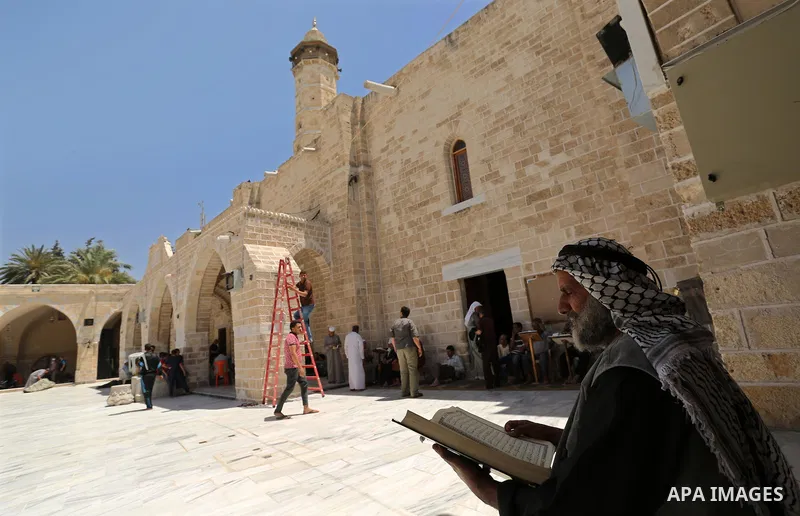 A Palestinian man reads a copy of the Koran, Islam's holiest book, on the first day of fasting in the Muslim holy month of Ramadan, at the al-Omari mosque in Gaza City, on May 27, 2017. Ramadan is sacred to Muslims becau...