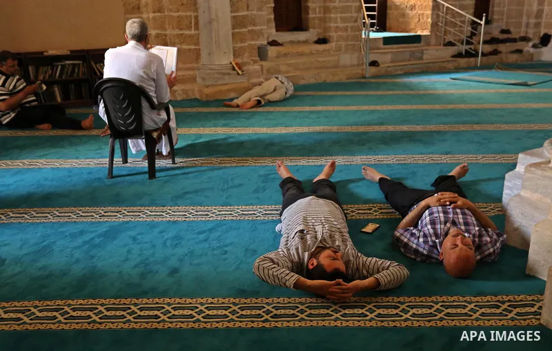 A Palestinian man reads a copy of the Koran, Islam's holiest book, on the first day of fasting in the Muslim holy month of Ramadan, at the al-Omari mosque in Gaza City, on May 27, 2017. Ramadan is sacred to Muslims becau...