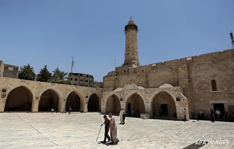 Palestinians walk at the al-Omari mosque after pray on the first day of fasting in the Muslim holy month of Ramadan, in Gaza City, on May 27, 2017. Ramadan is sacred to Muslims because it is during that month that tradit...