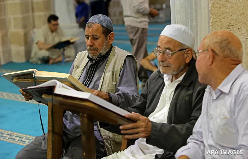 Palestinians read copies of the Koran, Islam's holiest book, on the first day of fasting in the Muslim holy month of Ramadan, at the al-Omari mosque in Gaza City, on May 27, 2017. Ramadan is sacred to Muslims because it...