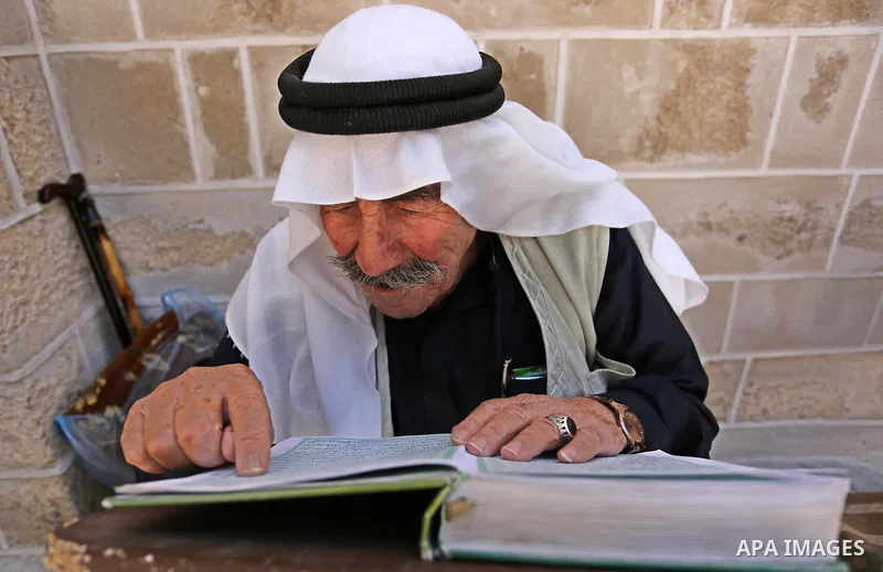 A Palestinian man reads a copy of the Koran, Islam's holiest book, on the first day of fasting in the Muslim holy month of Ramadan, at the al-Omari mosque in Gaza City, on May 27, 2017. Ramadan is sacred to Muslims becau...
