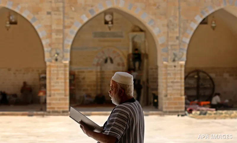 A Palestinian man reads a copy of the Koran, Islam's holiest book, on the first day of fasting in the Muslim holy month of Ramadan, at the al-Omari mosque in Gaza City, on May 27, 2017. Ramadan is sacred to Muslims becau...