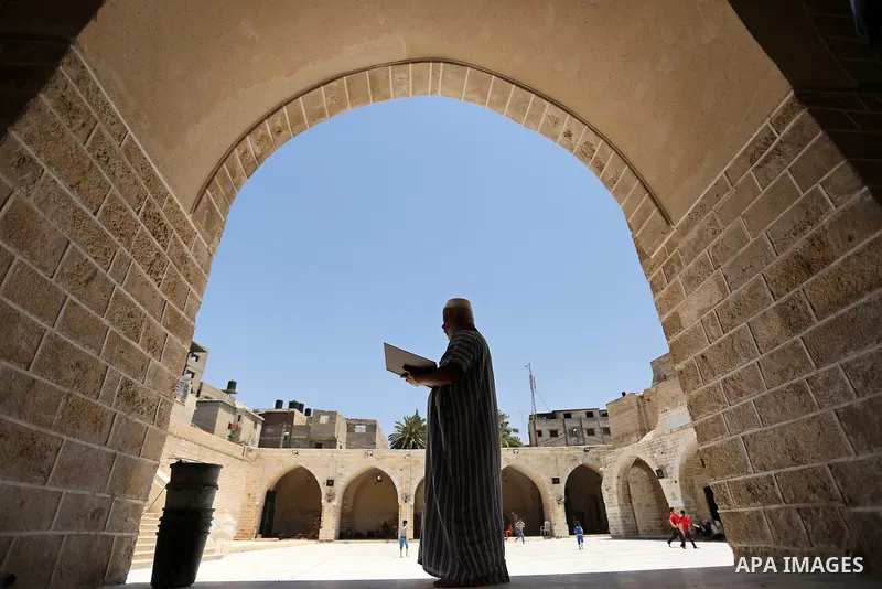 A Palestinian man reads a copy of the Koran, Islam's holiest book, on the first day of fasting in the Muslim holy month of Ramadan, at the al-Omari mosque in Gaza City, on May 27, 2017. Ramadan is sacred to Muslims becau...