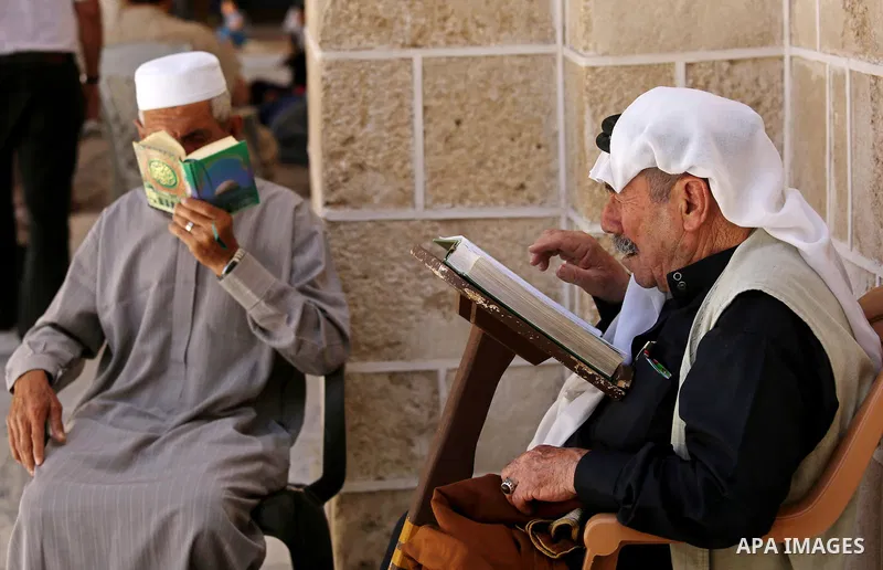 Palestinians read copies of the Koran, Islam's holiest book, on the first day of fasting in the Muslim holy month of Ramadan, at the al-Omari mosque in Gaza City, on May 27, 2017. Ramadan is sacred to Muslims because it...