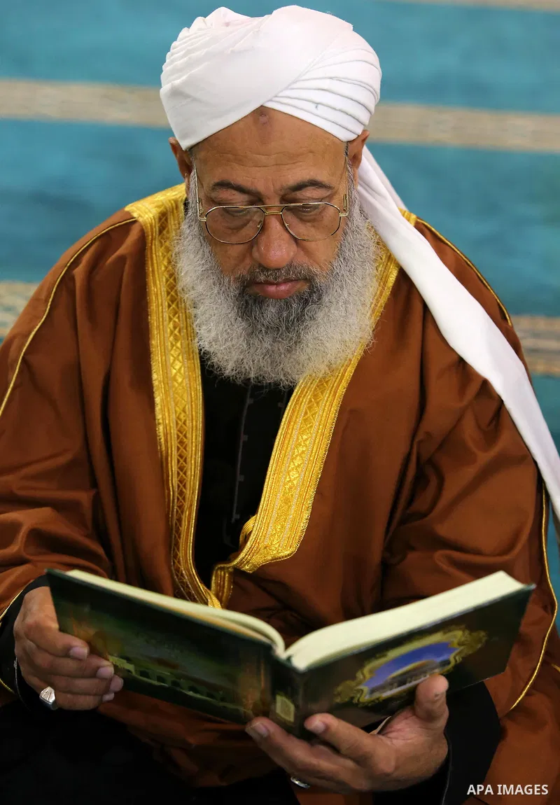 A Palestinian man reads a copy of the Koran, Islam's holiest book, on the first day of fasting in the Muslim holy month of Ramadan, at the al-Omari mosque in Gaza City, on May 27, 2017. Ramadan is sacred to Muslims becau...