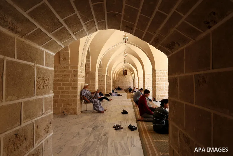 A Palestinian man reads a copy of the Koran, Islam's holiest book, on the first day of fasting in the Muslim holy month of Ramadan, at the al-Omari mosque in Gaza City, on May 27, 2017. Ramadan is sacred to Muslims becau...