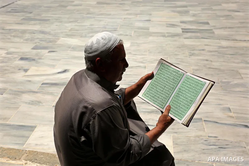A Palestinian man reads a copy of the Koran, Islam's holiest book, on the first day of fasting in the Muslim holy month of Ramadan, at the al-Omari mosque in Gaza City, on May 27, 2017. Ramadan is sacred to Muslims becau...
