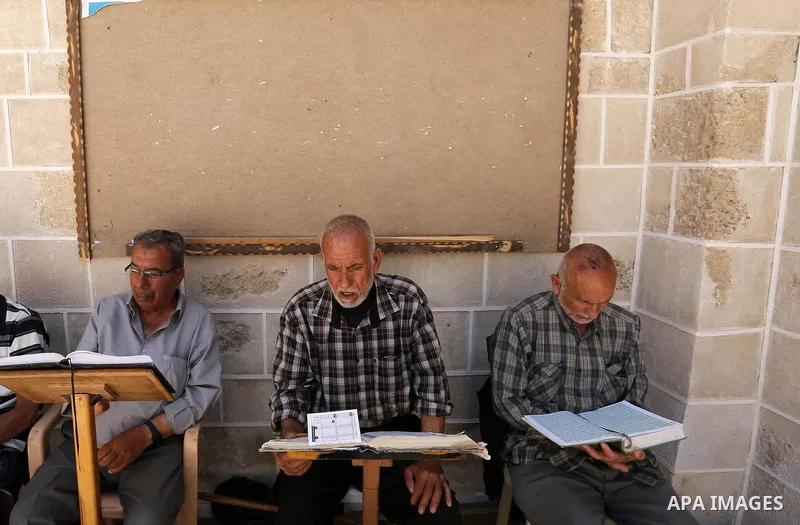 Palestinians read copies of the Koran, Islam's holiest book, on the first day of fasting in the Muslim holy month of Ramadan, at the al-Omari mosque in Gaza City, on May 27, 2017. Ramadan is sacred to Muslims because it...