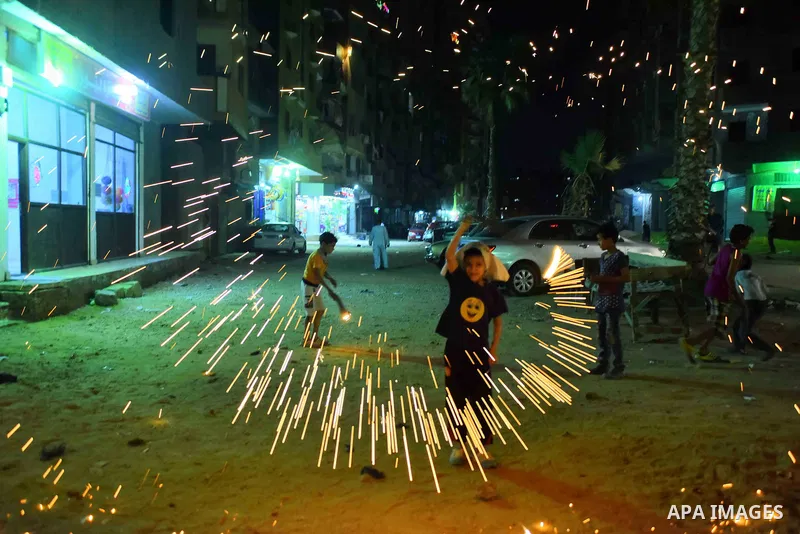 An Egyptian boy plays with fire crackers at street celebrating on the holy month of Ramadan in Cairo Egypt, on May 27, 2017. Ramadan is sacred to Muslims because it is during that month that tradition says the Koran was...