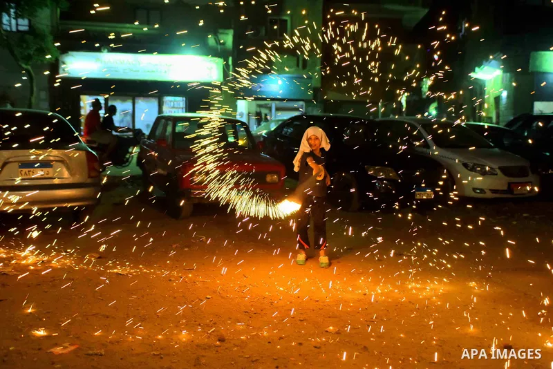 An Egyptian boy plays with fire crackers at street celebrating on the holy month of Ramadan in Cairo Egypt, on May 27, 2017. Ramadan is sacred to Muslims because it is during that month that tradition says the Koran was...