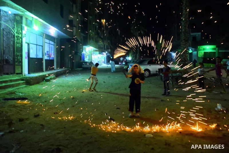 An Egyptian boy plays with fire crackers at street celebrating on the holy month of Ramadan in Cairo Egypt, on May 27, 2017. Ramadan is sacred to Muslims because it is during that month that tradition says the Koran was...
