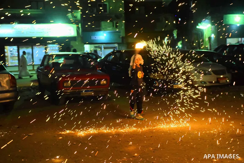 An Egyptian boy plays with fire crackers at street celebrating on the holy month of Ramadan in Cairo Egypt, on May 27, 2017. Ramadan is sacred to Muslims because it is during that month that tradition says the Koran was...