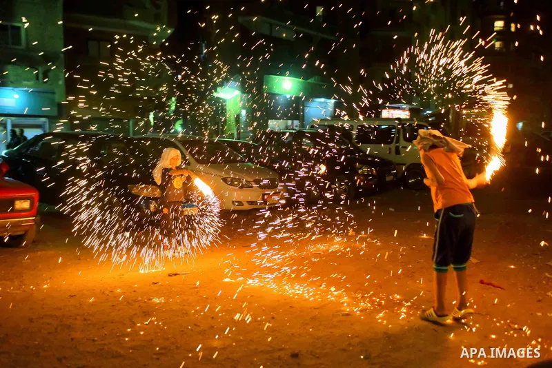 An Egyptian boy plays with fire crackers at street celebrating on the holy month of Ramadan in Cairo Egypt, on May 27, 2017. Ramadan is sacred to Muslims because it is during that month that tradition says the Koran was...