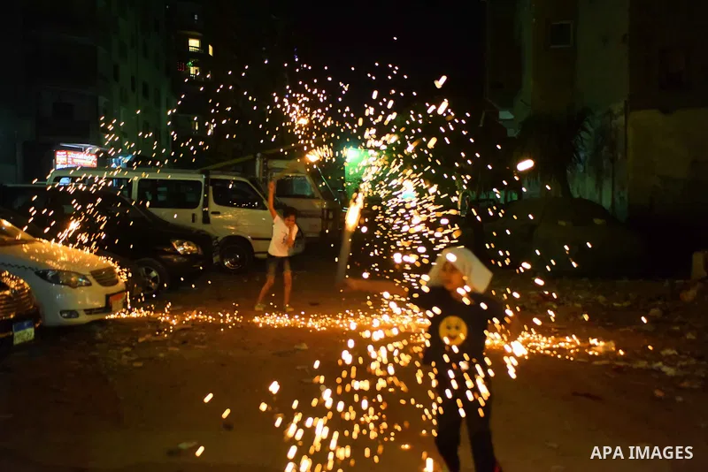 An Egyptian boy plays with fire crackers at street celebrating on the holy month of Ramadan in Cairo Egypt, on May 27, 2017. Ramadan is sacred to Muslims because it is during that month that tradition says the Koran was...