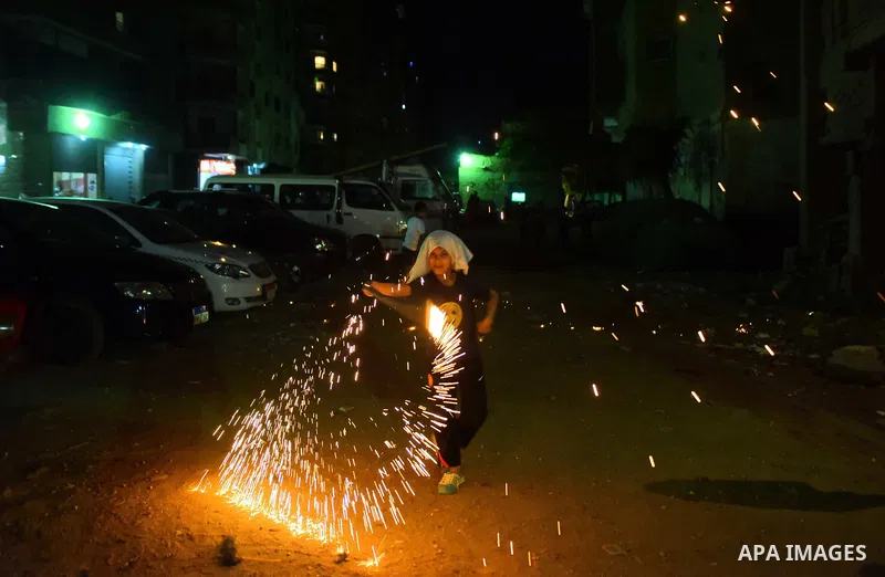 An Egyptian boy plays with fire crackers at street celebrating on the holy month of Ramadan in Cairo Egypt, on May 27, 2017. Ramadan is sacred to Muslims because it is during that month that tradition says the Koran was...