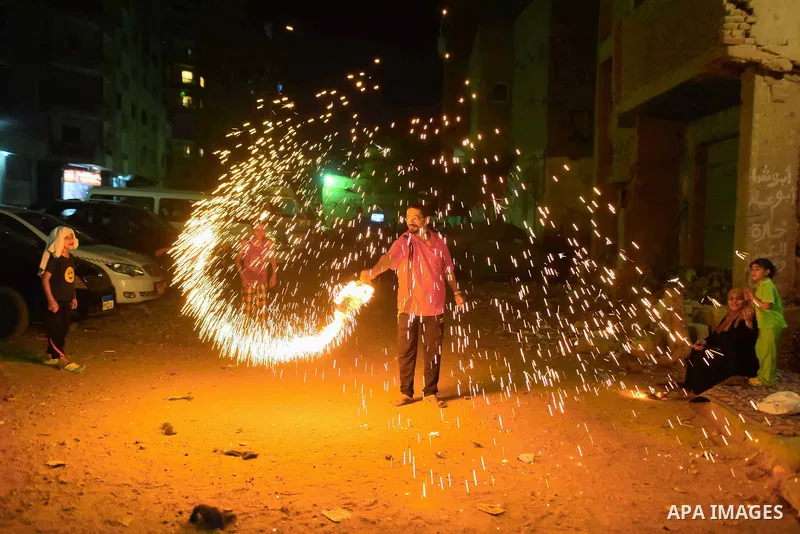 An Egyptian boy plays with fire crackers at street celebrating on the holy month of Ramadan in Cairo Egypt, on May 27, 2017. Ramadan is sacred to Muslims because it is during that month that tradition says the Koran was...