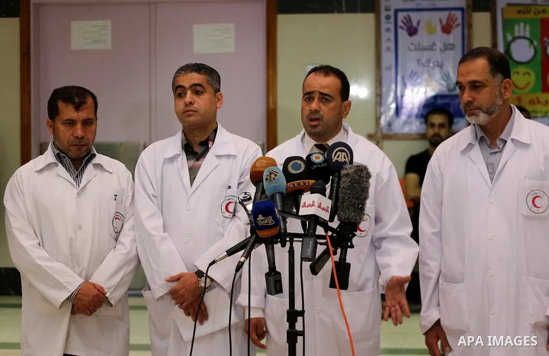 Palestinian doctors hold a press conference about halting shipments of baby formula and medicines to hospitals on Gaza strip, in Gaza city on May 28, 2017. Photo by Mohammed Asad
