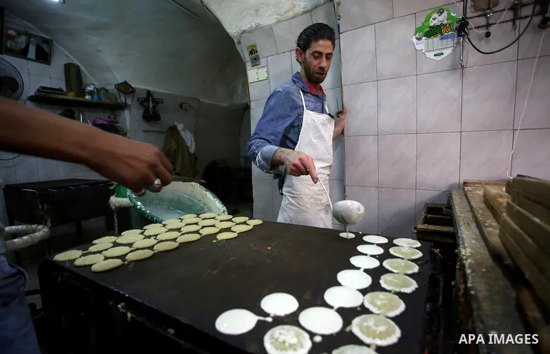 A Palestinian vendor sells traditional pancakes known as ''Qatayef'' on the Muslim holy fasting month of Ramadan at his shop in the Old City of the West Bank town of Nablus on May 28, 2017. Ramadan is sacred to Muslims b...