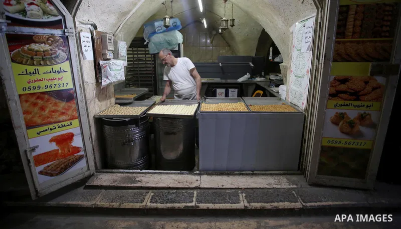 A Palestinian vendor sells traditional pancakes known as ''Qatayef'' on the Muslim holy fasting month of Ramadan at his shop in the Old City of the West Bank town of Nablus on May 28, 2017. Ramadan is sacred to Muslims b...
