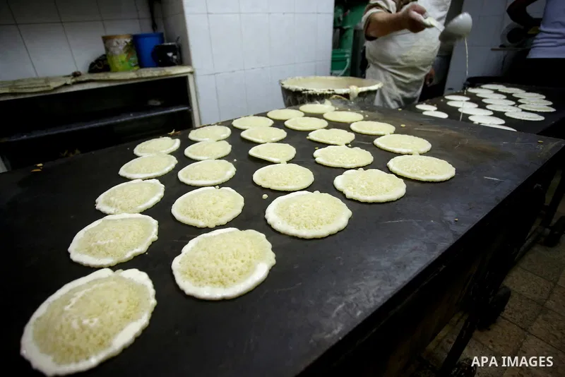 A Palestinian vendor prepares traditional pancakes known as ''Qatayef'' on the Muslim holy fasting month of Ramadan at his shop in the Old City of the West Bank town of Nablus on May 28, 2017. Ramadan is sacred to Muslim...