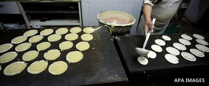 A Palestinian vendor prepares traditional pancakes known as ''Qatayef'' on the Muslim holy fasting month of Ramadan at his shop in the Old City of the West Bank town of Nablus on May 28, 2017. Ramadan is sacred to Muslim...