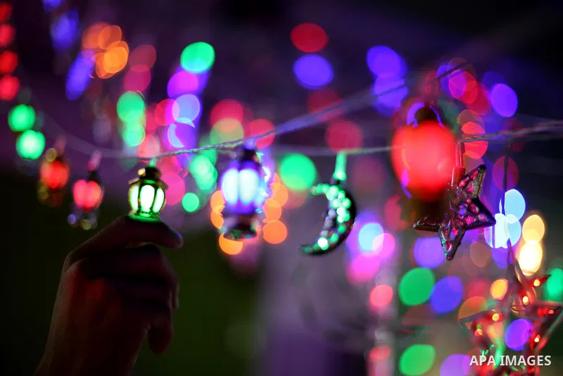 A Palestinian vendor decorates his shop with traditional lanterns known in Arabic as "Fanous" and festive lights on the Muslim holy fasting month of Ramadan on Gaza city on May 28, 2017. Ramadan is sacred to Muslims beca...