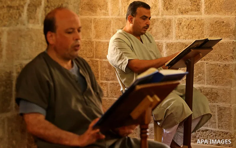 Palestinian men read copies of the Koran, Islam's holiest book, on the Muslim holy fasting month of Ramadan at the al- Sayed Hashim mosque in Gaza city on May 29, 2017. Ramadan is sacred to Muslims because it is during t...