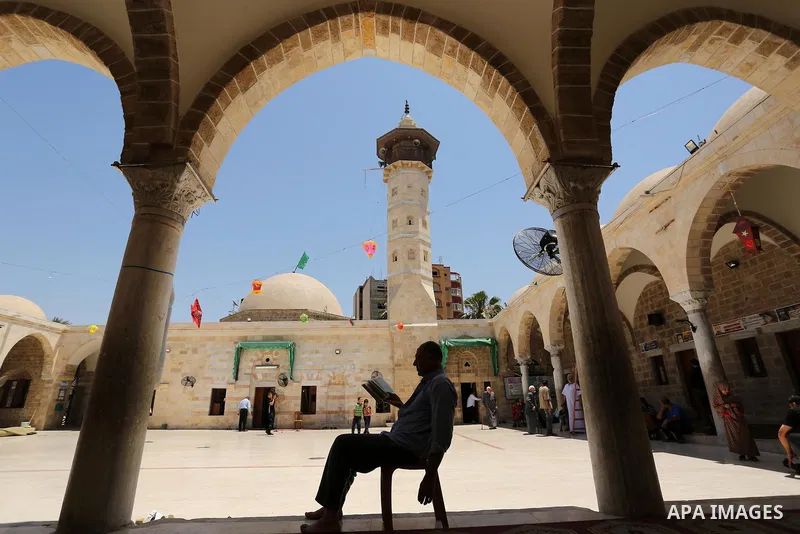 A Palestinian man reads a copy of the Koran, Islam's holiest book, on the Muslim holy fasting month of Ramadan at the al- Sayed Hashim mosque in Gaza city on May 29, 2017. Ramadan is sacred to Muslims because it is durin...
